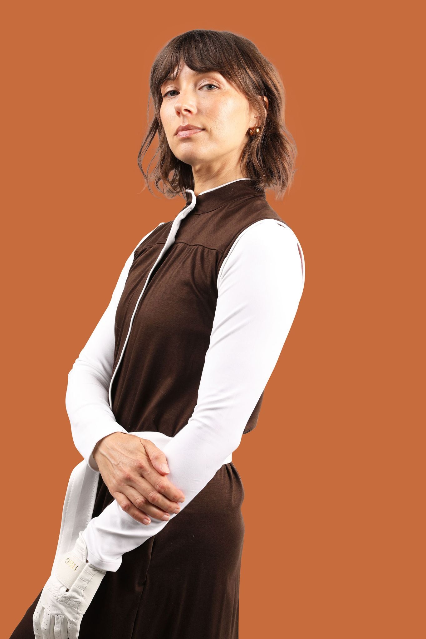 Women's golfer in sustainably made brown golf dress